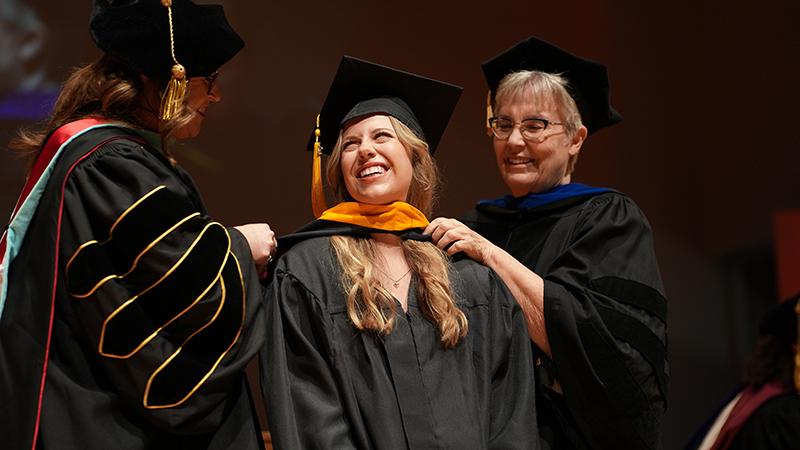 Graduate hooded by professors