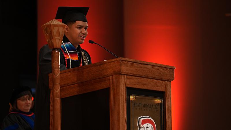 Student graduate speaks at podium